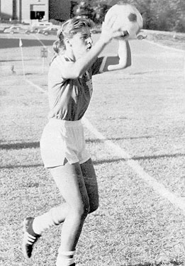 Women's soccer player throwing ball