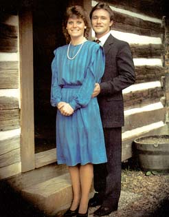 Homecoming King and Queen posing by the duck pond cabin.