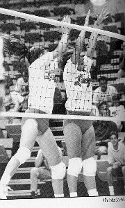 LadyKats blocking a volleyball
