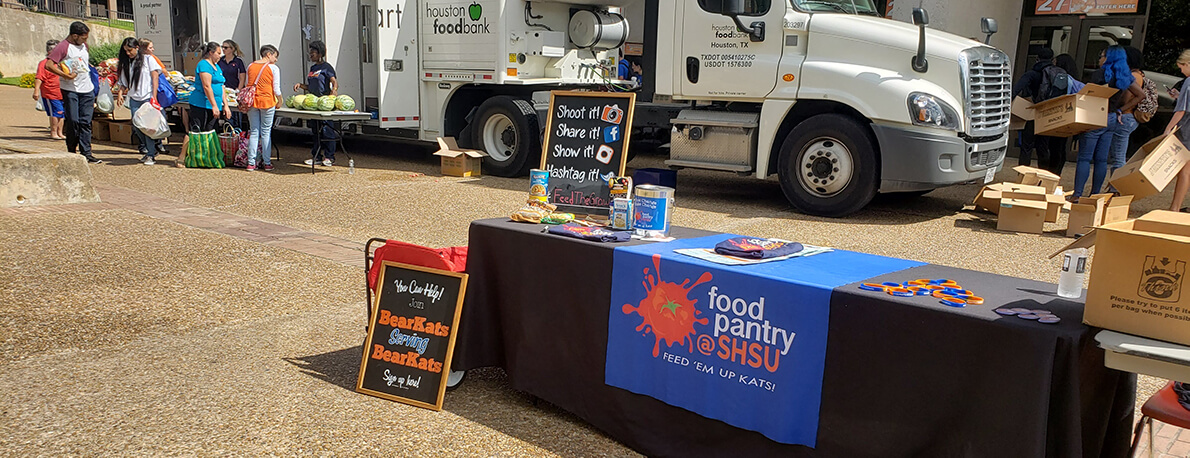 Food Pantry table in front of Houston Food Bank truck