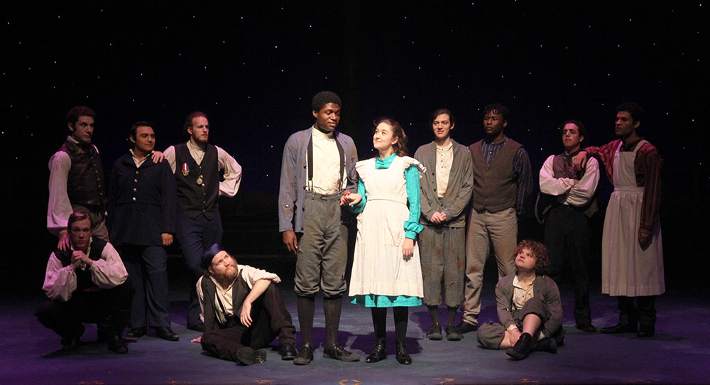 SHSU theatre actors making eye contact and linking arms on stage in  Peter and the Starcatcher