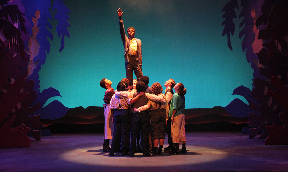 SHSU theatre actors on stage lifting the lead in Peter and the Starcatcher