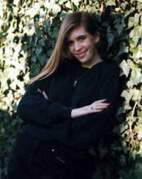 Erica Starr leaning against an ivy-covered wall