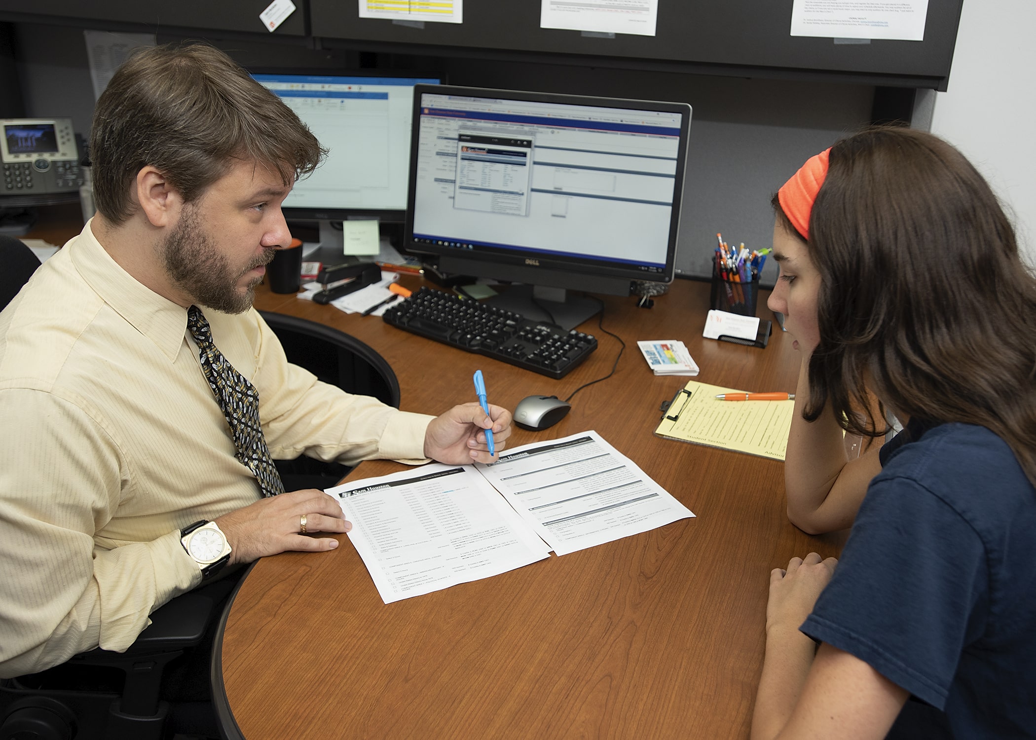 A student being given options for course selections during advising.