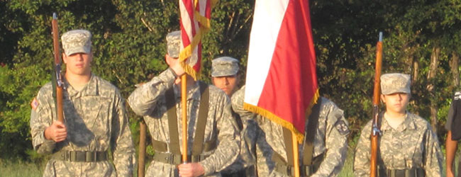 Soldiers in Uniform with Flags and Guns