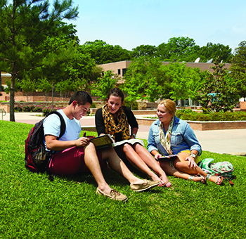 Students sat on the lawn reading