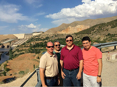Dr. Jaimie Hebert (SHSU Provost and Vice President of Academic Affairs), Dr. Asaf Varol (Dean of the College of Technology at Firat University), Dr. John Pascarella (Dean, SHSU College of Sciences), and Dr. Cihan Varol (Assistant Professor, SHSU Department of Computer Science) in front of a hydroelectric dam near Elazig, Turkey.