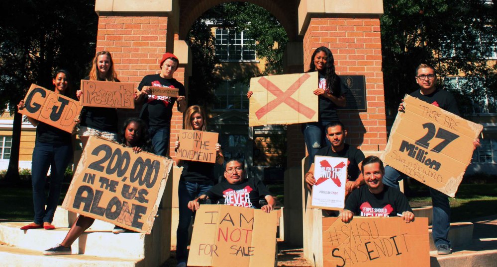 GCJD students holding their anti-slavery signs on campus