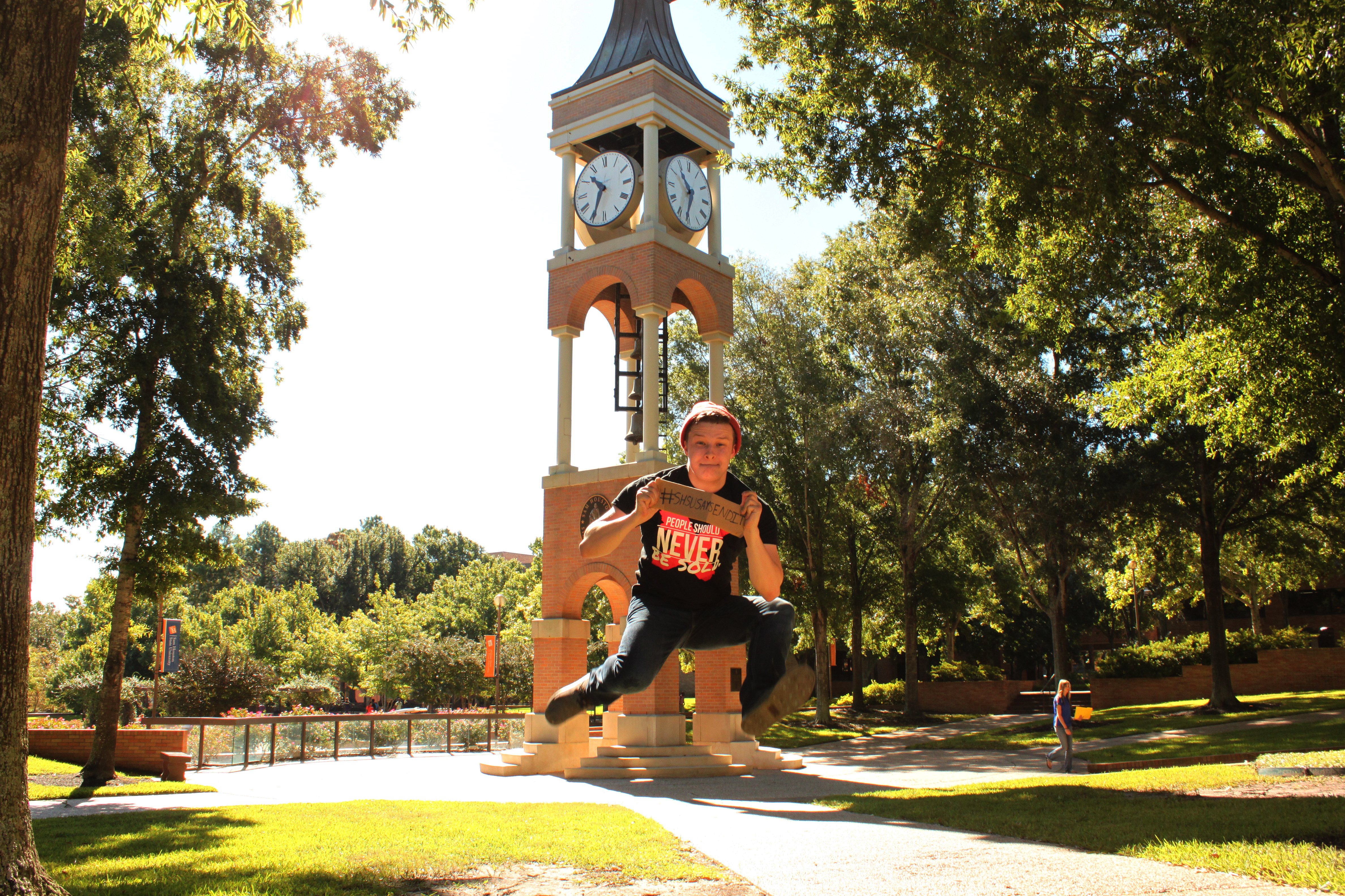 Lex in front of the clock tower on campus
