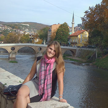 Miranda posing in front of a river in Bosnia