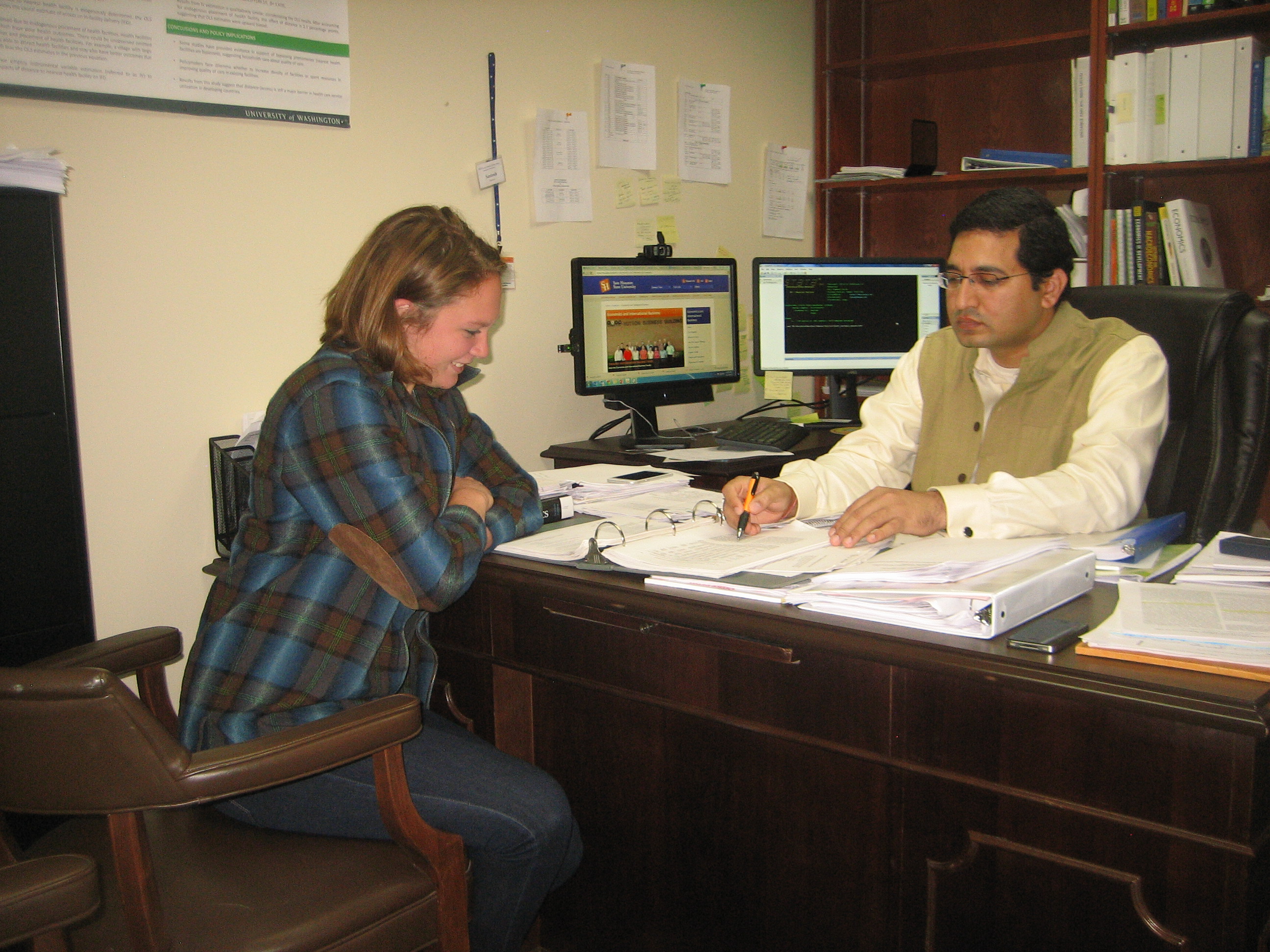Santosh Kumar and his undergraduate student madison becker work on research together.
