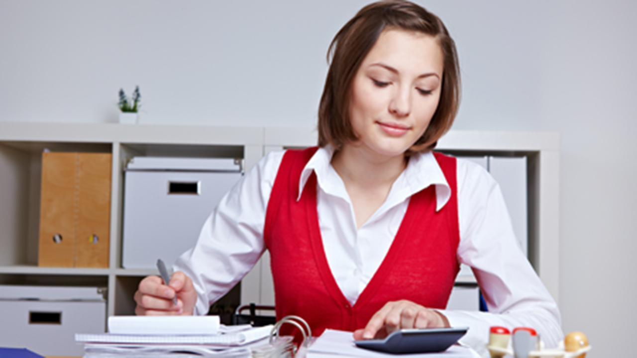 woman calculating at desk