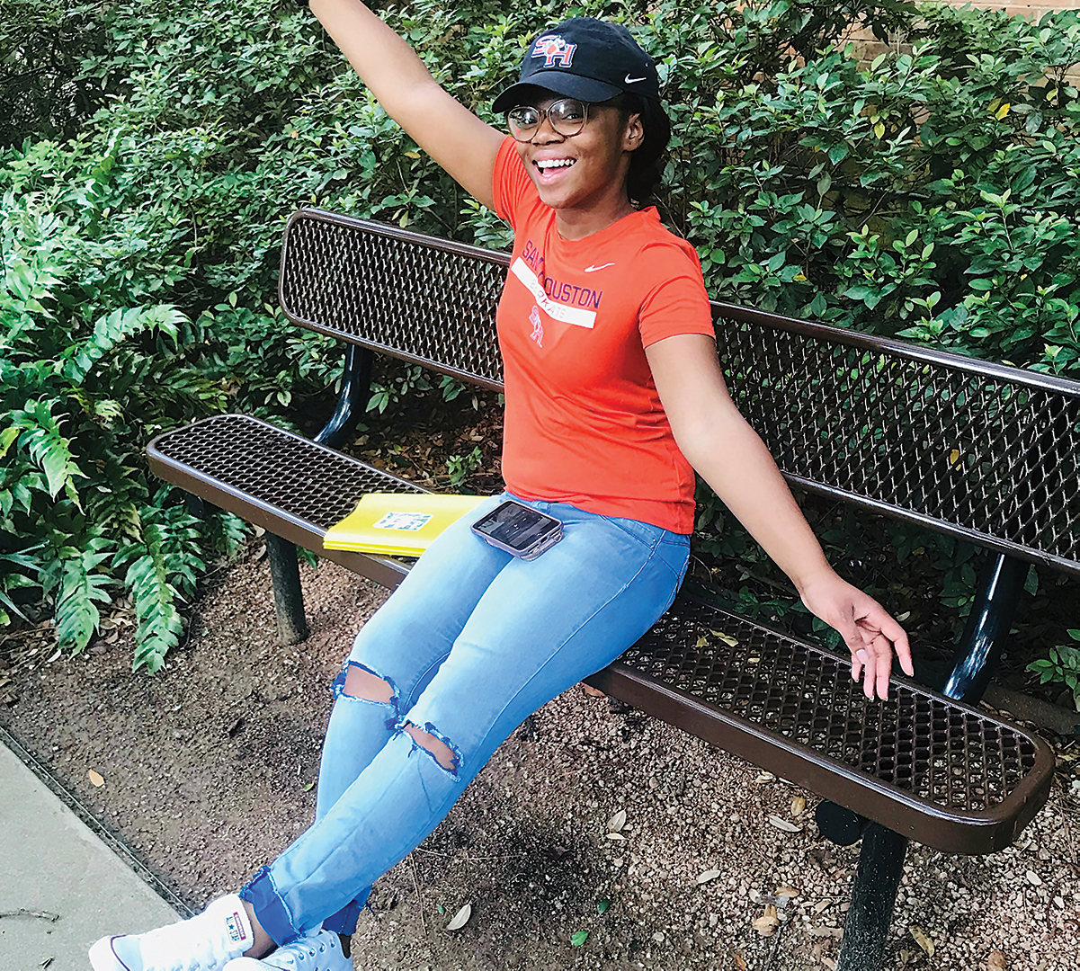 Danielle White posing on a park bench.
