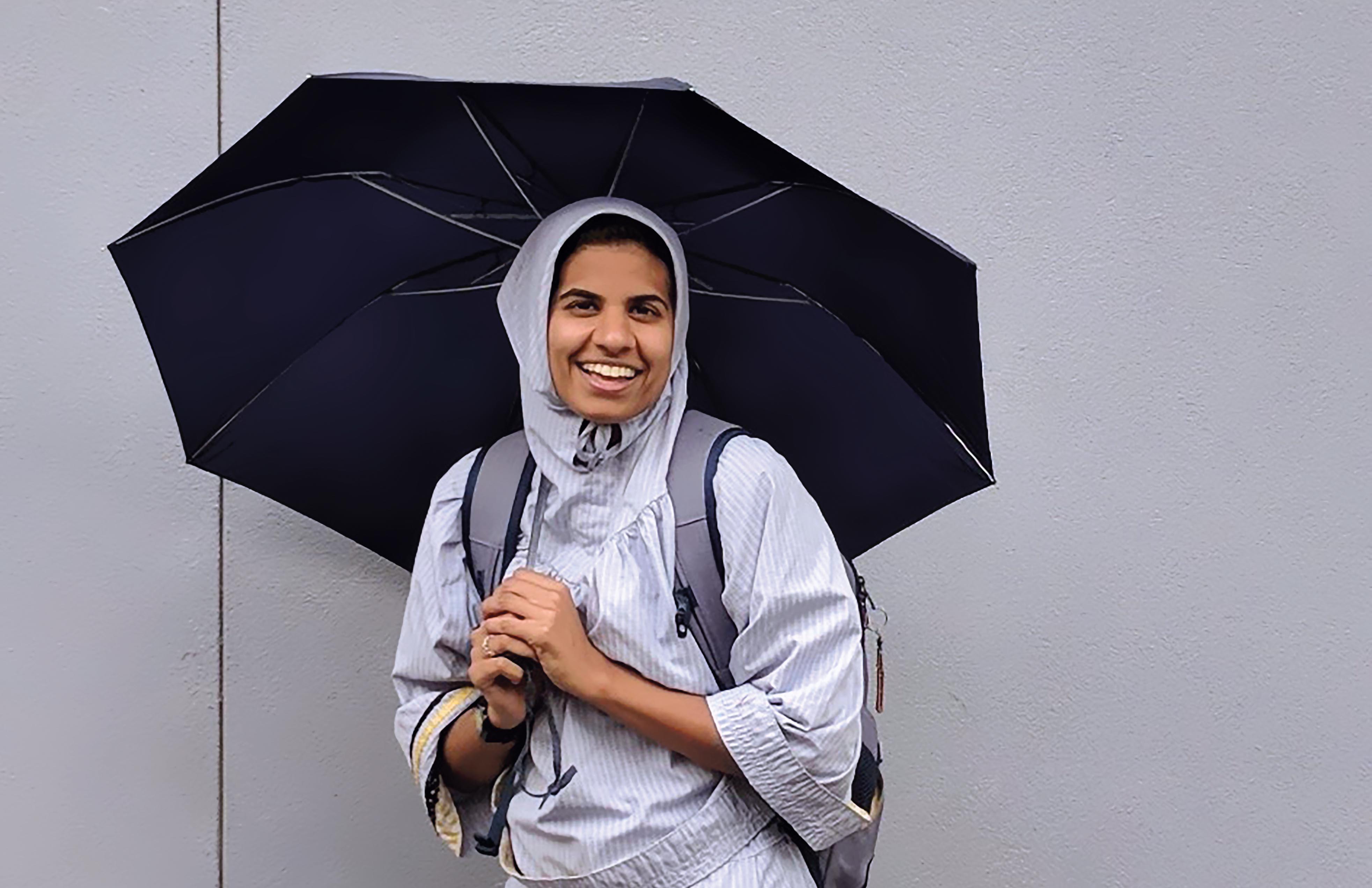 Jamila Raja holding an umbrella