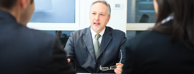 Businessman talking to two people
