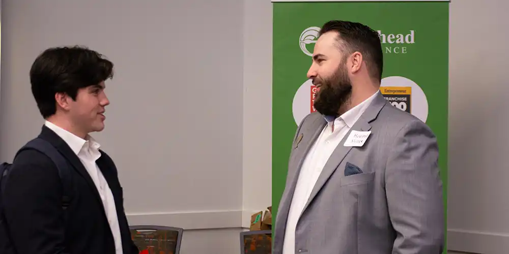 Business students discussing something at a recruiting event.