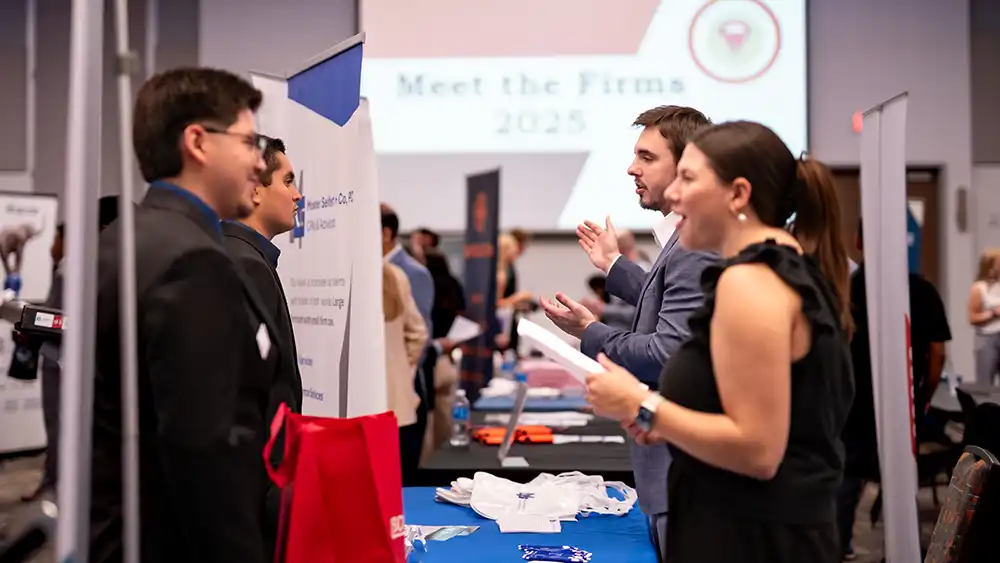 Students meeting with recruiters at booths at "Meet the Firms" 2025.