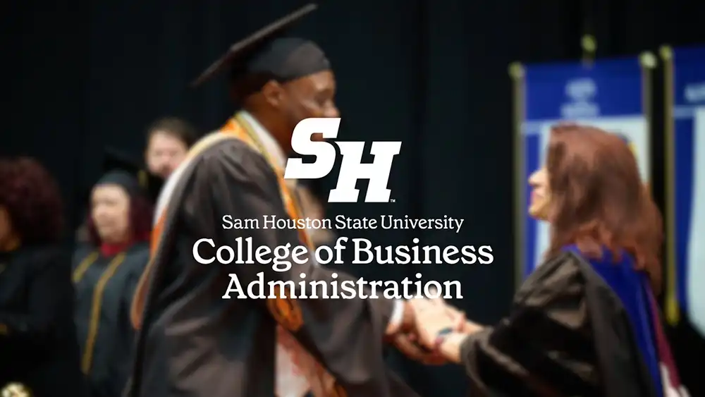 Business student receiving shaking hands with faculty at commencement, with the college mark superimposed on it.