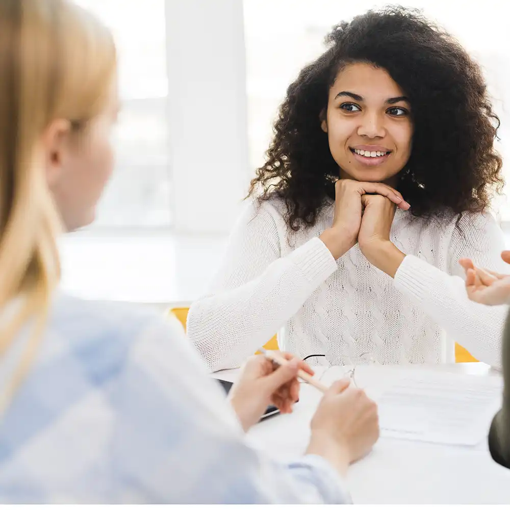Two women meeting, in a business setting.