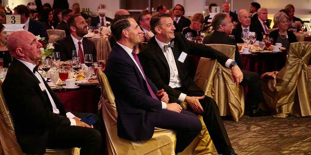 Attendees smiling in their seats at the Texas Bankers Hall of Fame gala.