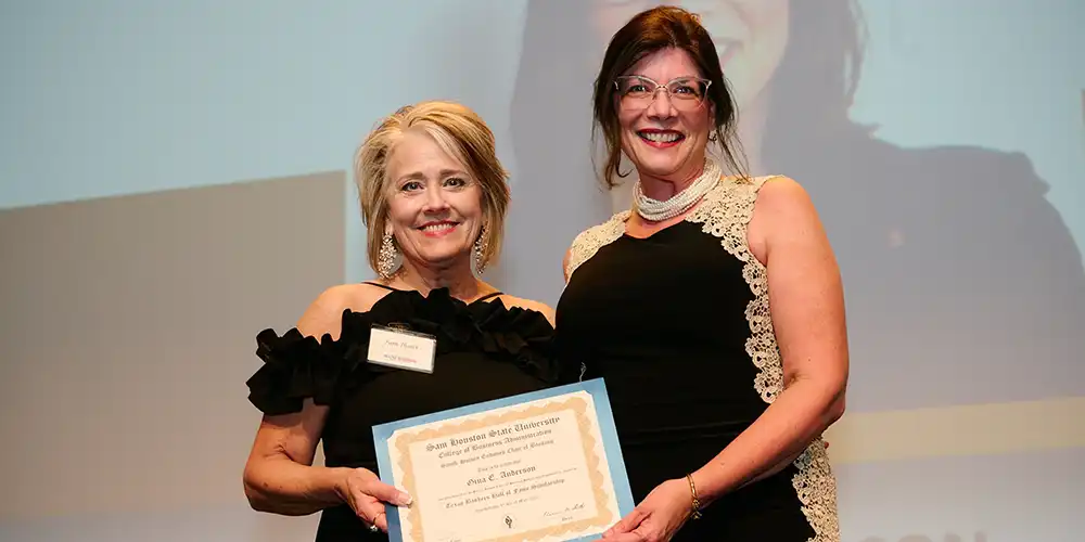 A scholarship recipient posing with the former Director of the Smith-Hutson Endowed Chair of Banking.