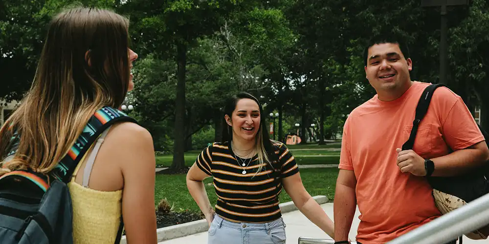 Students standing outdoors smiling