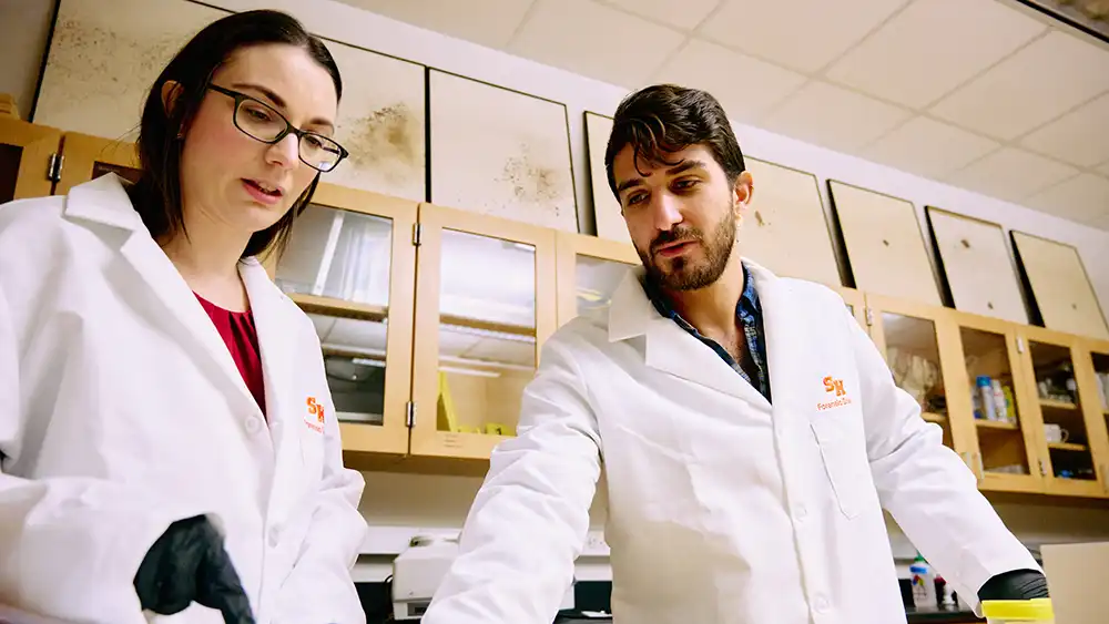 Students walking in lab area