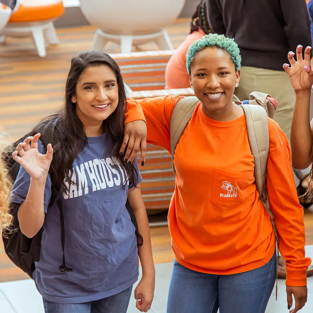 Two SHSU students pose in the Lowman Student Center.