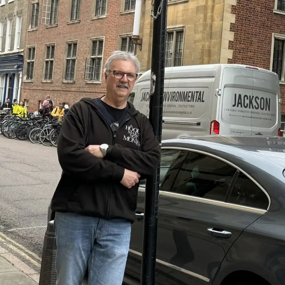 Dr. Robert Donahoo leans against a street post in London.