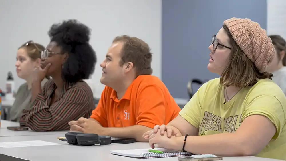 SHSU students sit listening to their professor's lecture.