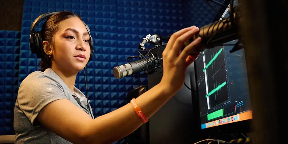 SHSU students works with microphones and audio tools in a the IRIS sound booth.