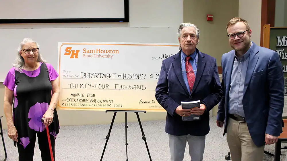 Donors Richard and Cynthia Traylor pose with a giant check for $34,000 with History Department chair, Dr. Brian Jordan.