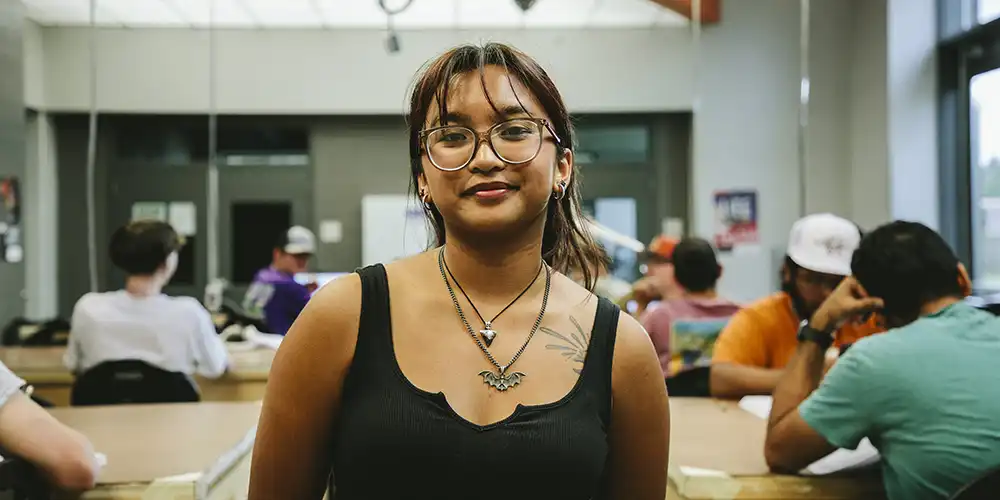 SHSU student poses for a photo in one of the labs.
