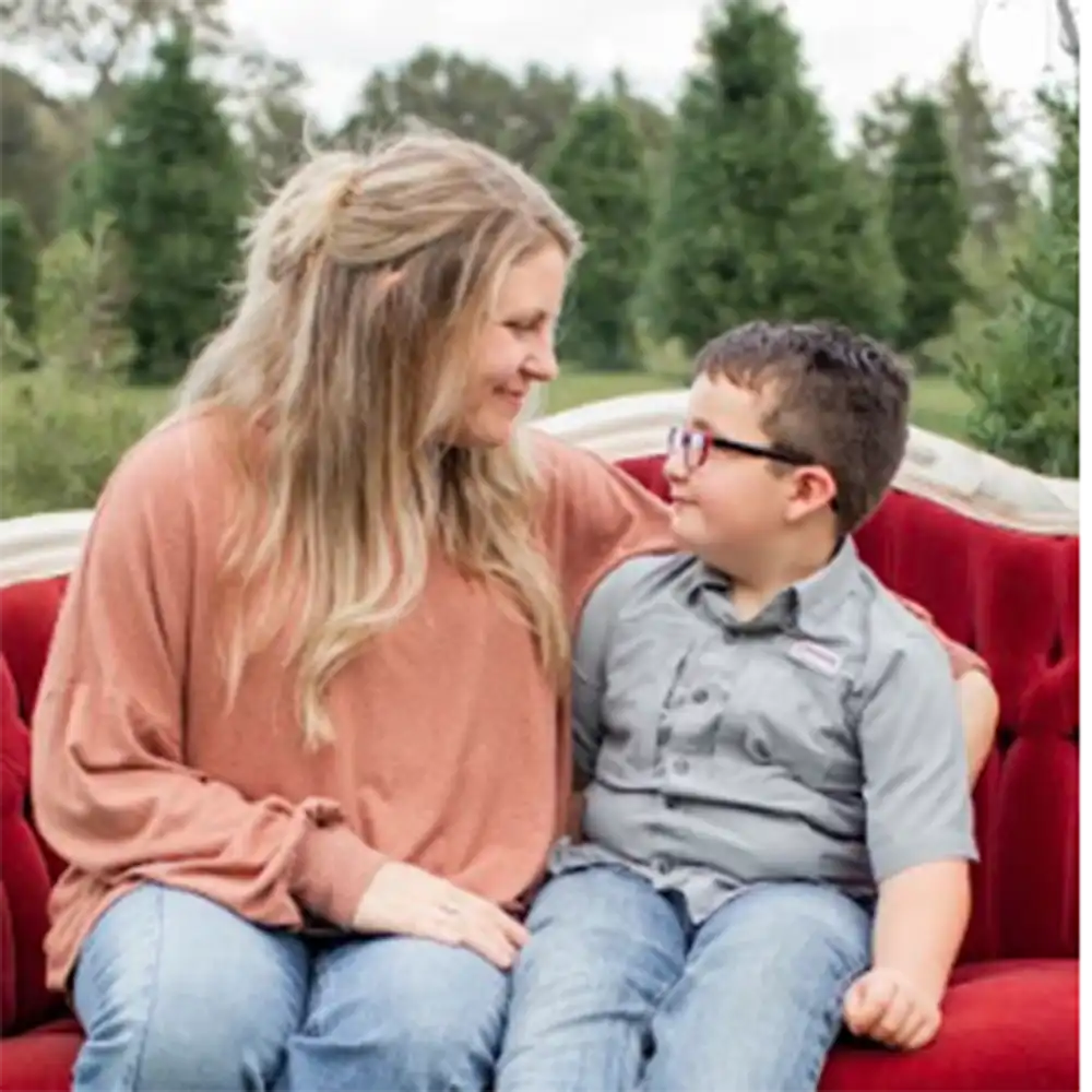 Madison and her son sit looking at each other sweetly.