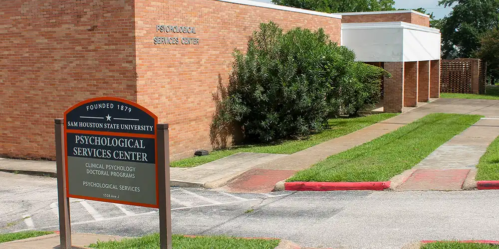 Outside photo of the Psychological Services Center that includes the sign.