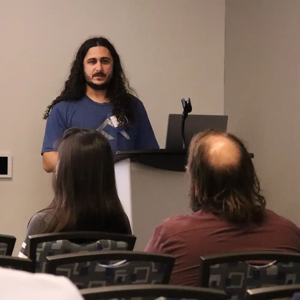 Dominic presents his research in front of a crowd at the SHSU Undergraduate Symposium