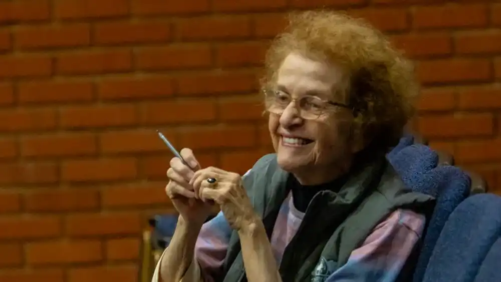 Dr. Conroy smiles as she sits as 'expert witness' during a mock trial. 