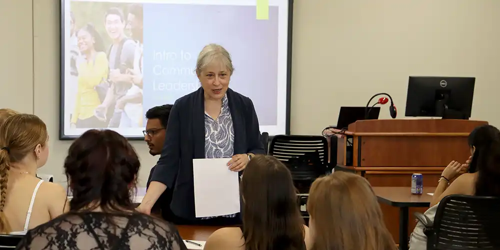 SHSU faculty speaks with students during a sociology class.
