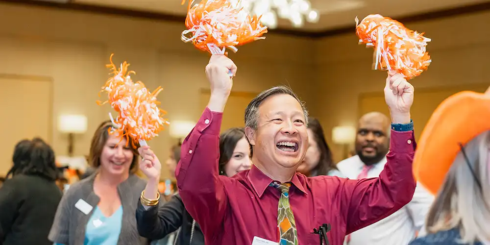 Faculty with pom poms celebrating commencement events