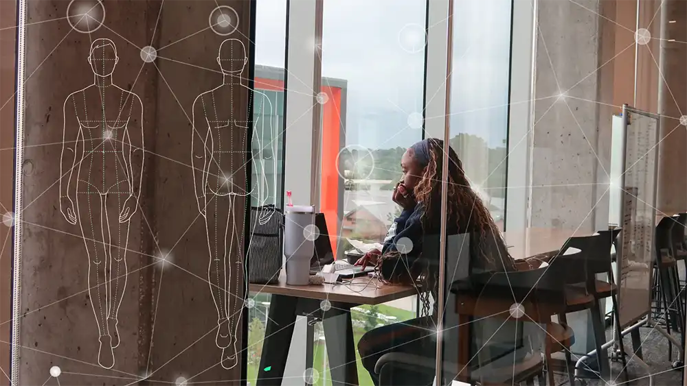 Student sitting at a desk on her laptop