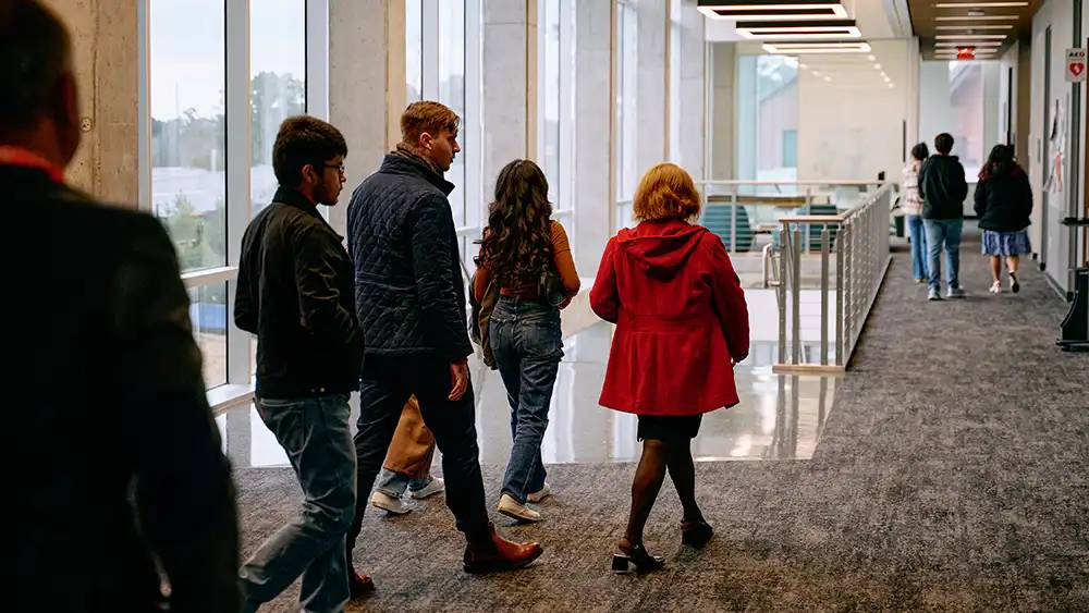 Group walking through SHSU-COM