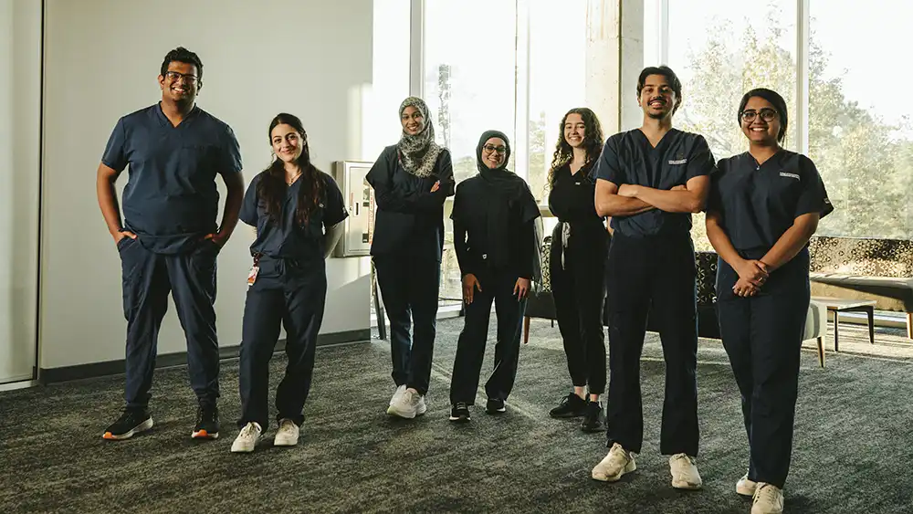 Doctor students standing in a hallway.