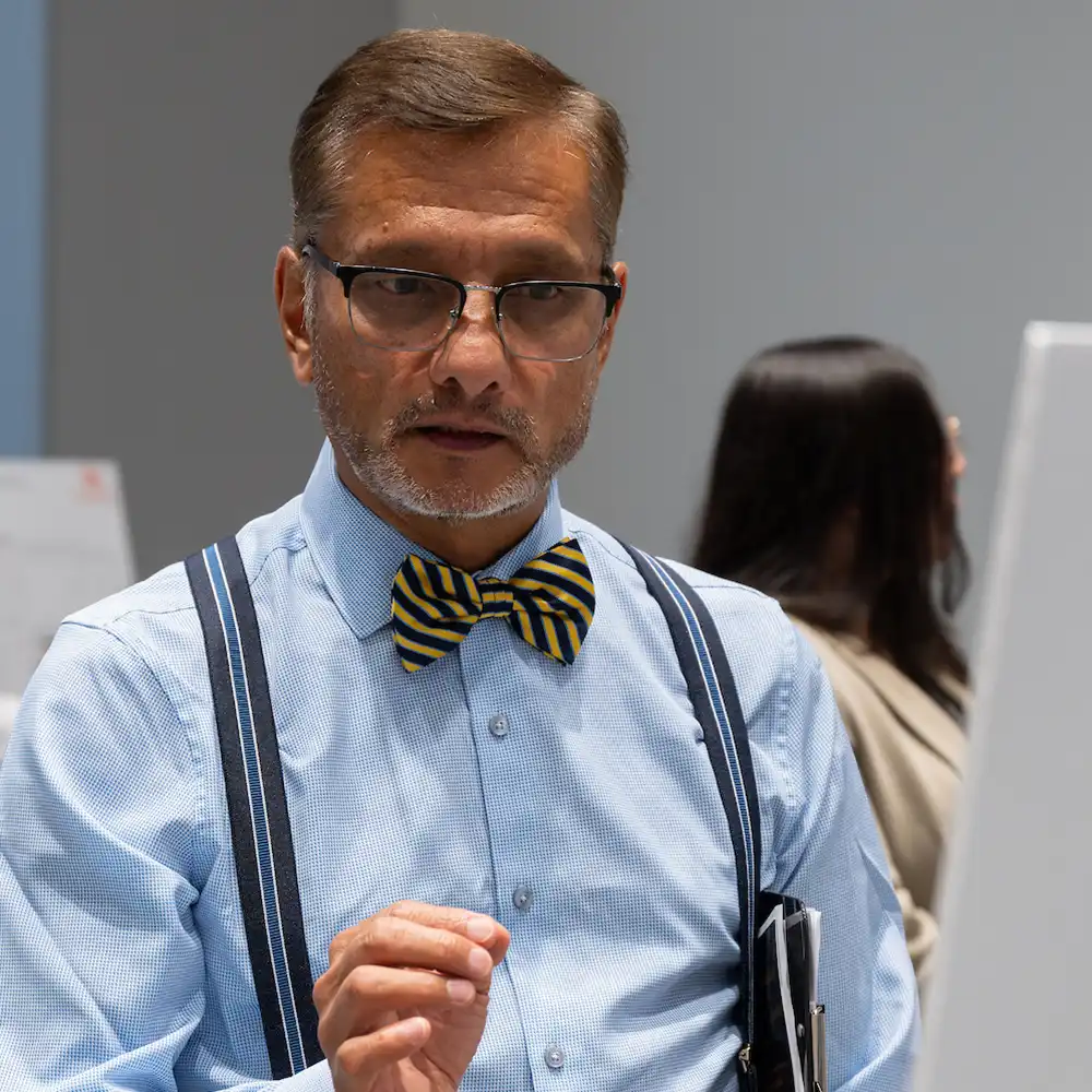 Student writing research results on glass with dry erase marker