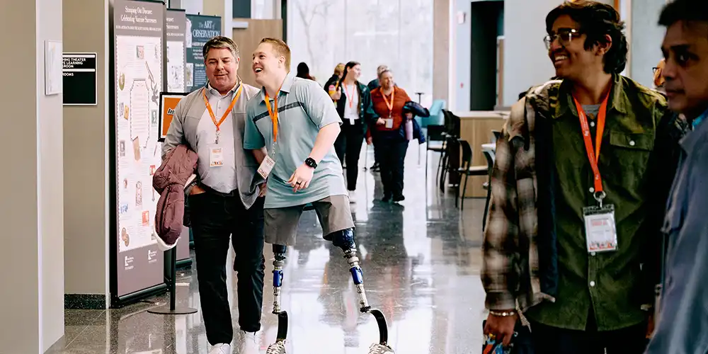 Students and their families walking and smiling in the halls of SHSU-COM