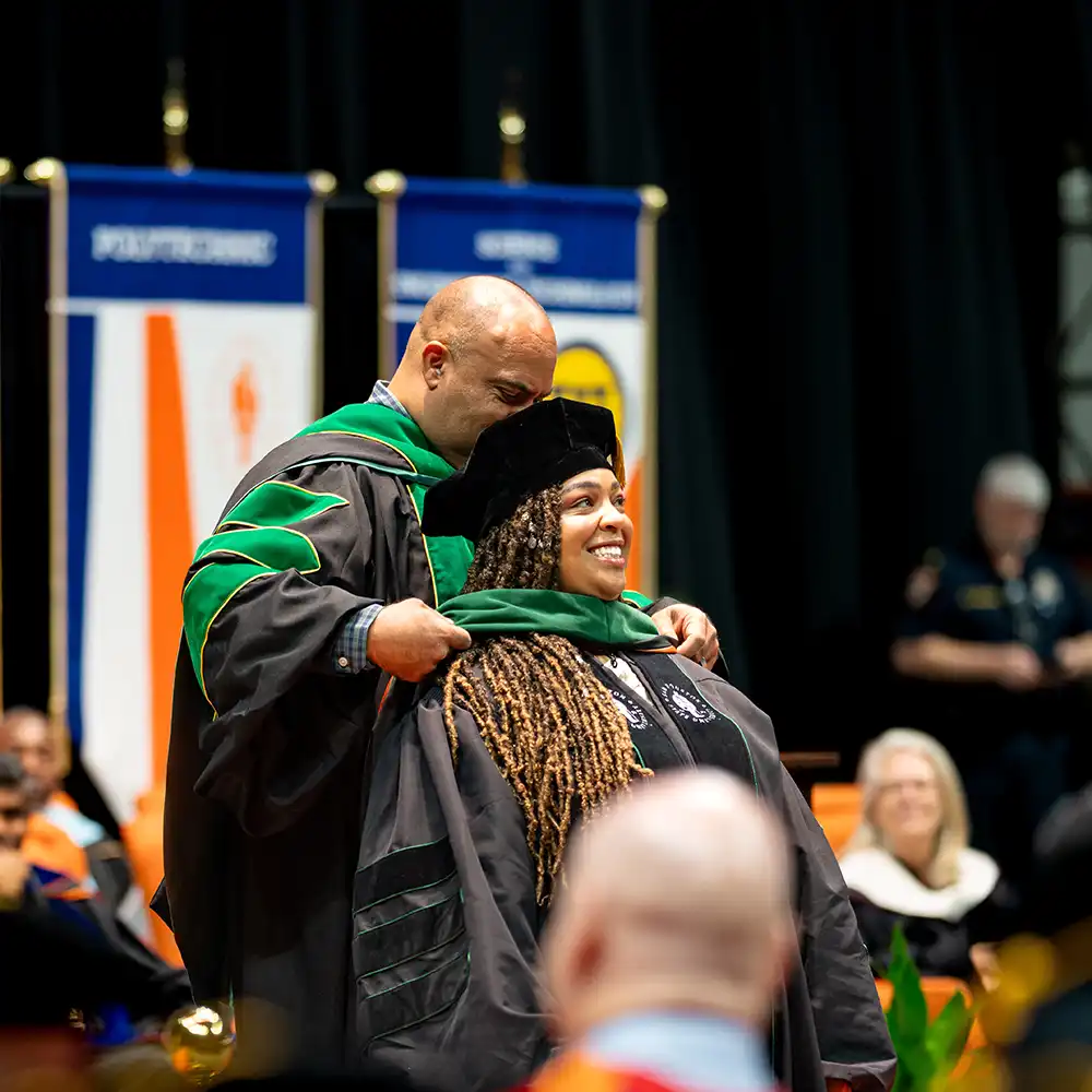 Doctor being hooded at COM commencement