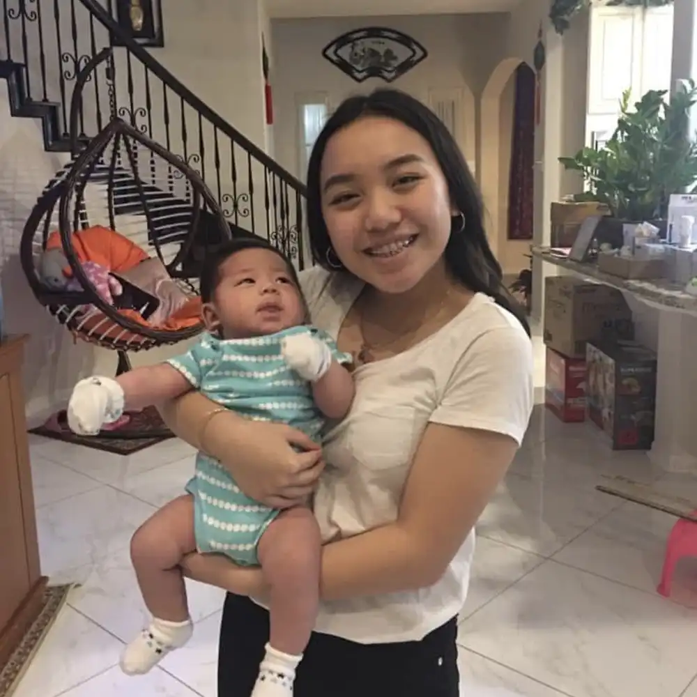 Julie holding her baby brother