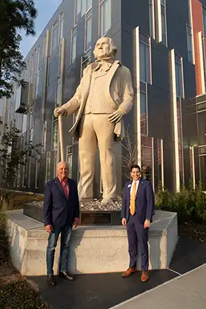 Dr. Vinn and Dr. Mohr in front of SHSU-COM | January 2026