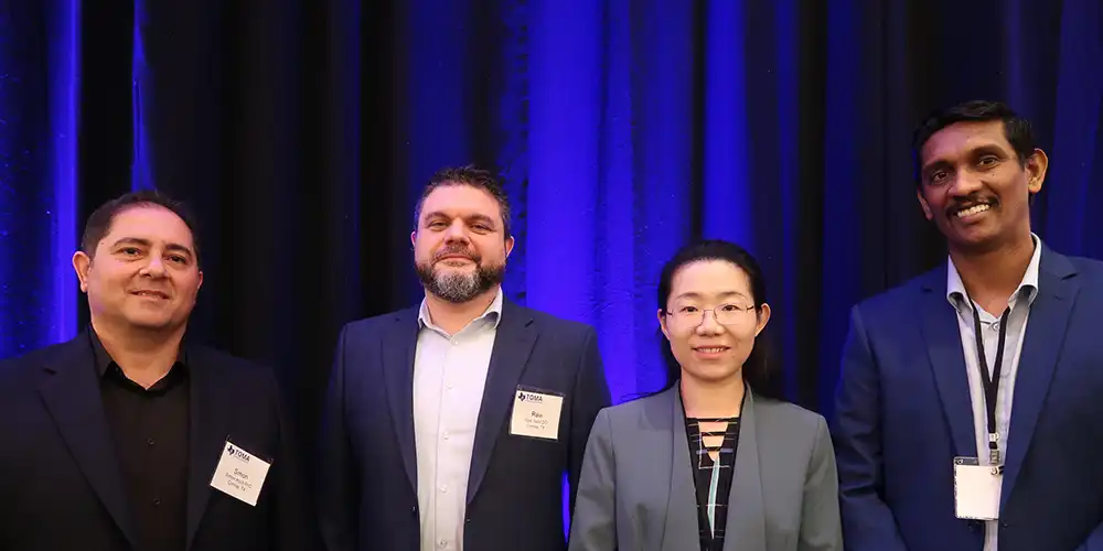 Biomedics Department faculty standing in a line on stage smiling