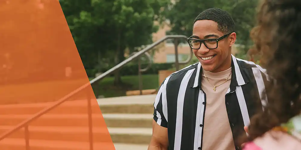 Student in front of stairs on campus