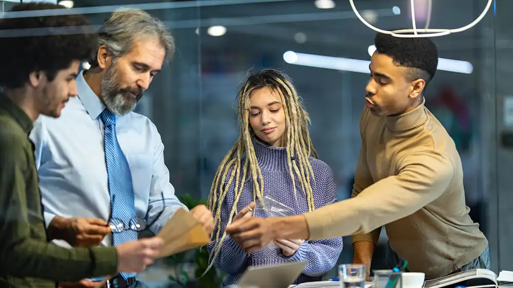 Professor working with three students.